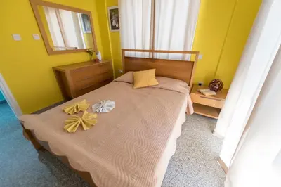 a bedroom with a bed with two flowers on it at Villa Marina in Ayia Napa