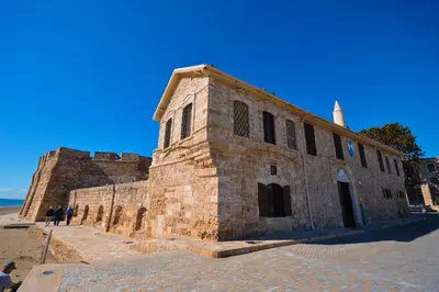 an old brick building on the side of a beach at Krasas Beach Apartment Rentals in Larnaka