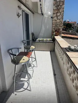 two chairs and a table on a balcony at Bar street apartment in Ayia Napa