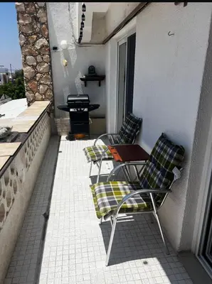 a patio with two chairs and a table on a balcony at Bar street apartment in Ayia Napa