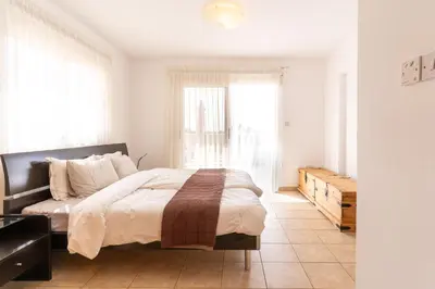 a bedroom with a large bed and a window at 300m to Nissi Beach, Pool & Sunny Terrace in Ayia Napa