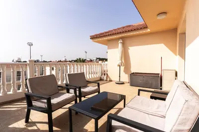 a patio with chairs and a table on a balcony at 300m to Nissi Beach, Pool & Sunny Terrace in Ayia Napa