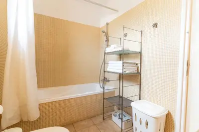 a bathroom with a tub and a toilet and a shower at 300m to Nissi Beach, Pool & Sunny Terrace in Ayia Napa