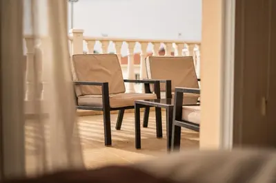 a couple of chairs sitting on a balcony at 300m to Nissi Beach, Pool & Sunny Terrace in Ayia Napa