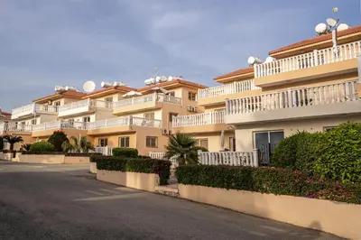 a large apartment building with white balconies and a street at 300m to Nissi Beach, Pool & Sunny Terrace in Ayia Napa