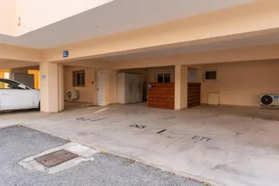 an empty garage with a car parked in it at 300m to Nissi Beach, Pool & Sunny Terrace in Ayia Napa