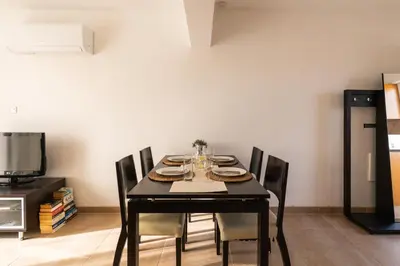 a dining room with a black table and chairs at 300m to Nissi Beach, Pool & Sunny Terrace in Ayia Napa
