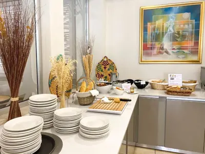 a kitchen with white plates on a counter at Anesis Hotel in Ayia Napa