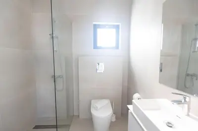 a bathroom with a toilet and a shower and a sink at Protaras Aqua Pearl Villa in Protaras