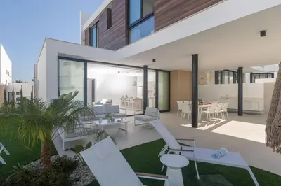 an image of a house with chairs and a patio at Protaras Aqua Pearl Villa in Protaras