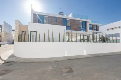 a white wall in front of a building at Protaras Aqua Pearl Villa in Protaras