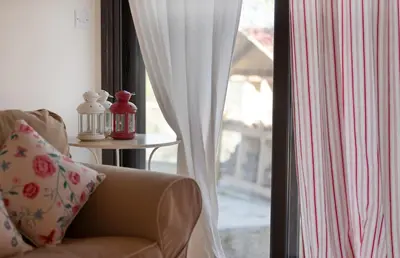 a living room with a chair and a window at Orama Mountain Villa Farmakas in Nicosia