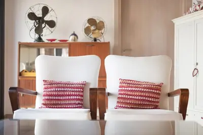 two white chairs with pillows on them in a room at Orama Mountain Villa Farmakas in Nicosia