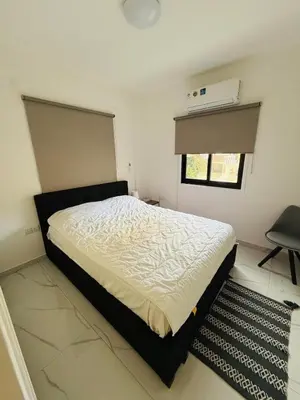a bedroom with a bed and a window at Brand new, Finikoudes area in Larnaka