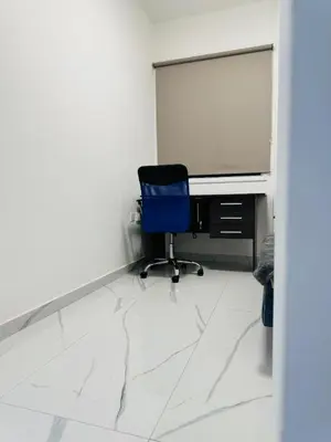 a blue chair sitting in front of a computer monitor at Brand new, Finikoudes area in Larnaka
