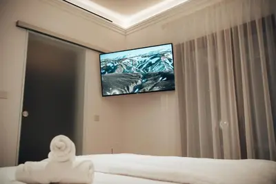 a bedroom with a flat screen tv on the wall at Hyperion Boutique Villa in Voroklini