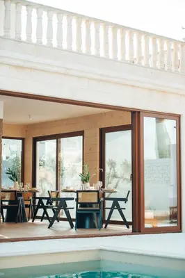 a house with a swimming pool and a patio at Hyperion Boutique Villa in Voroklini