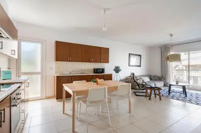 a kitchen and living room with a table and chairs at Center, Walking to the Beach in Larnaka