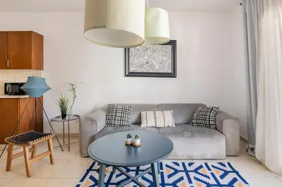 a living room with a couch and a table at Center, Walking to the Beach in Larnaka