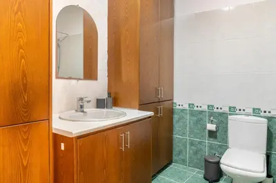 a bathroom with a sink and a toilet and a mirror at Center, Walking to the Beach in Larnaka