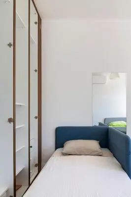 a bedroom with a blue bed and a mirror at Center, Walking to the Beach in Larnaka