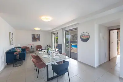 a dining room and living room with a table and chairs at Ayia Napa Satin Villa SVI3 in Ayia Napa