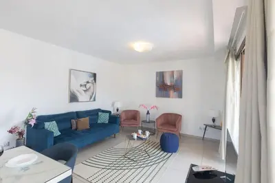 a living room with a blue couch and chairs at Ayia Napa Satin Villa SVI3 in Ayia Napa