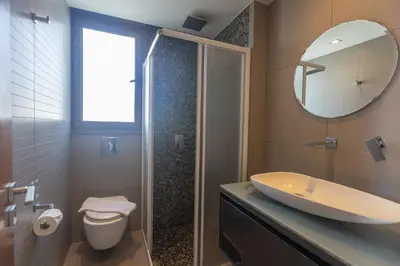 a bathroom with a sink and a toilet and a mirror at Ayia Napa Satin Villa SVI3 in Ayia Napa