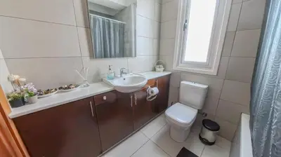 a bathroom with a sink and a toilet and a mirror at Hi royal villa in Pervolia