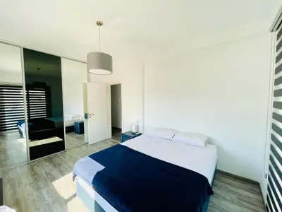 a bedroom with a large bed and a mirror at LimassolStar Etko Area in Limassol