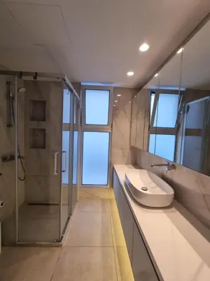 a bathroom with a shower and a toilet and a sink at Luxury Seafront 2 bedroom in Limassol