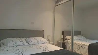 a bedroom with two beds and a mirror at Luxury Seafront 2 bedroom in Limassol