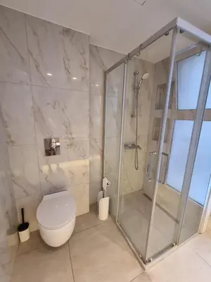 a bathroom with a shower and a toilet at Luxury Seafront 2 bedroom in Limassol