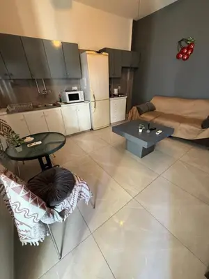 a living room with a table and a couch at D Pitsillos Homes luxury in Larnaka