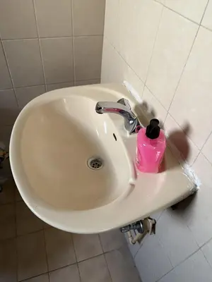 a bathroom sink with a pink cup on it at D Pitsillos Homes luxury in Larnaka