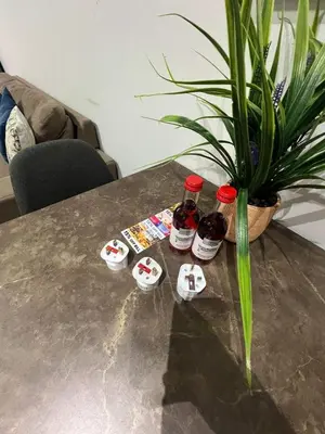 a table with three bottles of jam and a plant at D Pitsillos Homes luxury in Larnaka