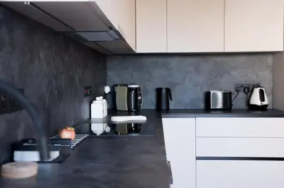 a kitchen with white cabinets and a counter top at Delightful 1st Floor Xanthippis Apartment in Strovolos