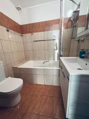 a bathroom with a tub and a toilet and a sink at Kapparis Pleasure Familly Lounge in Paralimni