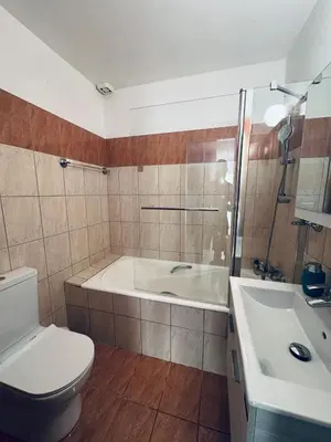a bathroom with a tub and a toilet and a sink at Kapparis Pleasure Familly Lounge in Paralimni