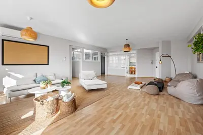 a living room with white furniture and a flat screen tv at St Lazar Penthouse Apartment in Larnaka