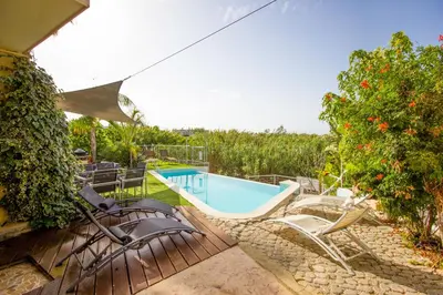 a patio with chairs and a swimming pool at Gold Sand Villa in Protaras
