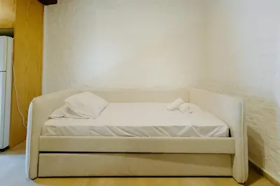 a white bed with two towels on it in a room at Rustic Elegance in Omodos in Omodos