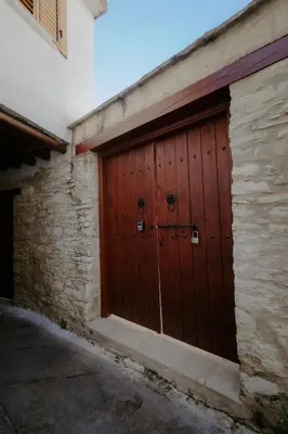 a pair of wooden doors on the side of a building at Rustic Elegance in Omodos in Omodos