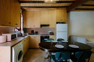 a kitchen with a table with chairs and a tableasteryasteryasteryasteryasteryastery at Rustic Elegance in Omodos in Omodos