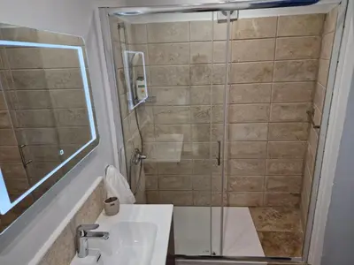 a bathroom with a shower and a sink at The Courtyard Suite in Limassol