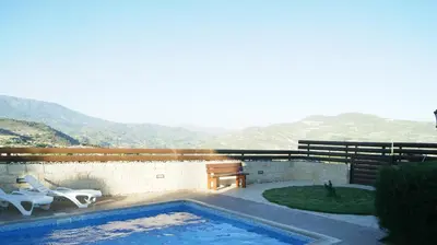 a swimming pool with a view of a mountain at Softades Cottage in Omodos
