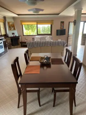 a living room with a table and a couch at Softades Cottage in Omodos
