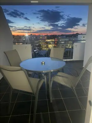 a table and chairs on a balcony with a view at Elegant 2BR Apartment- La Vie Royale in Nicosia