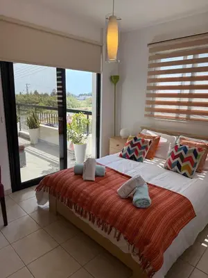 a bedroom with a large bed with a large window at Green valley Tersefanou in Tersephanou