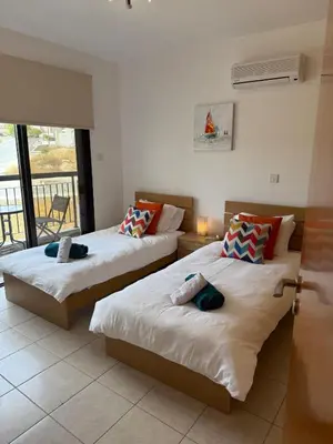 two beds in a room with a balcony at Green valley Tersefanou in Tersephanou